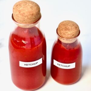 Two small bottles with ketchup