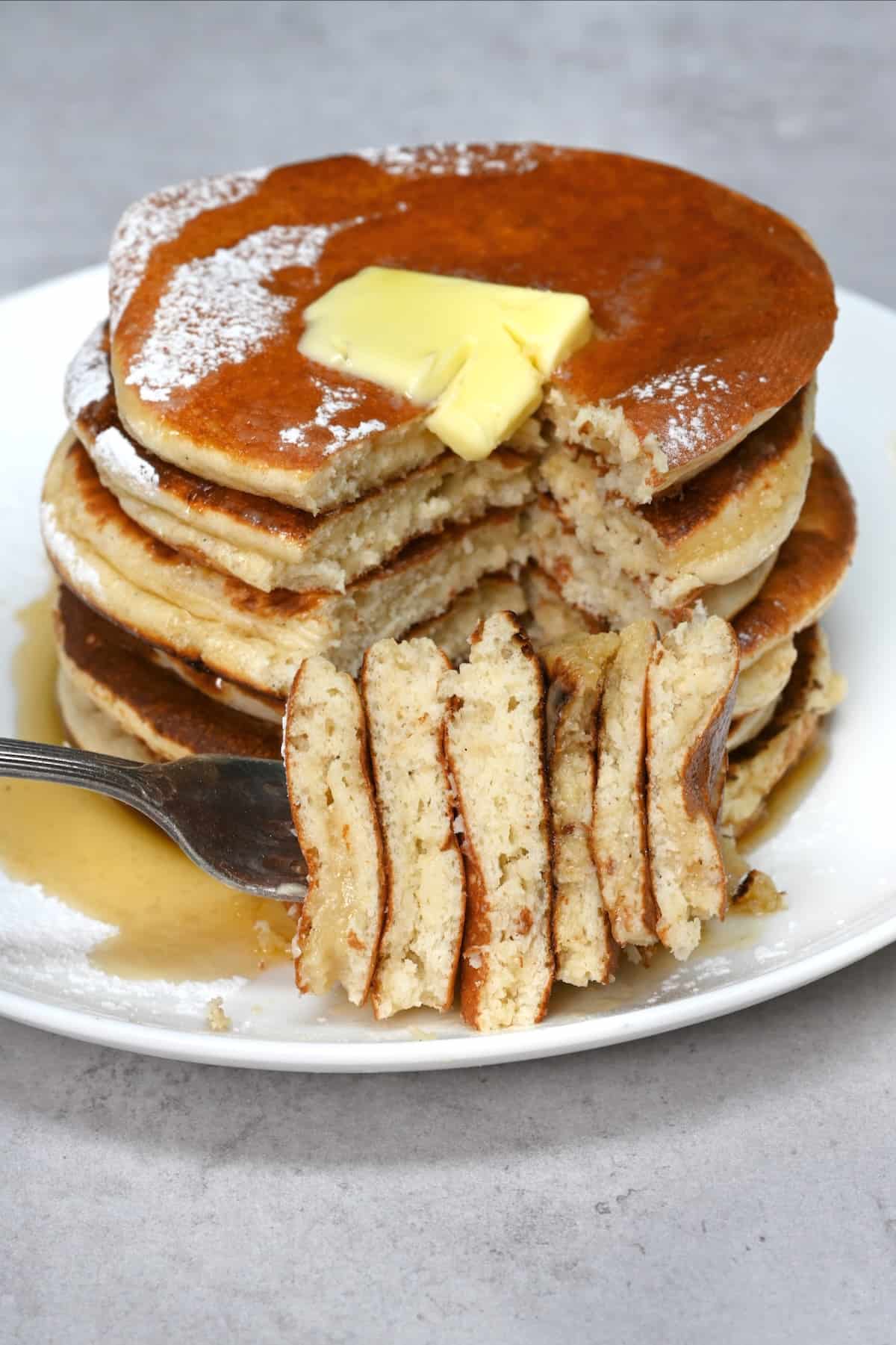 A stack of protein pancakes covered with with a pat of butter
