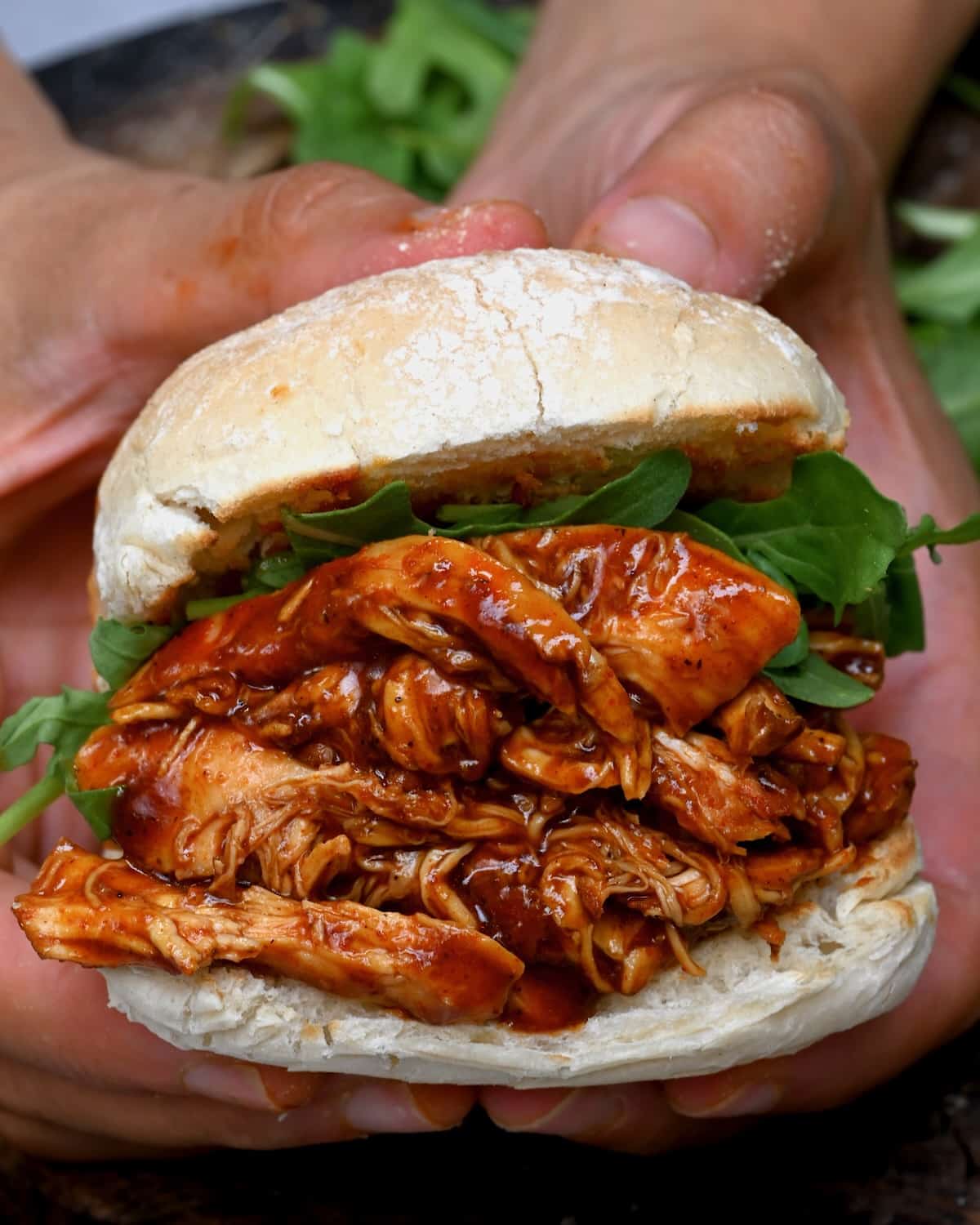 A sandwich with pulled BBQ chicken