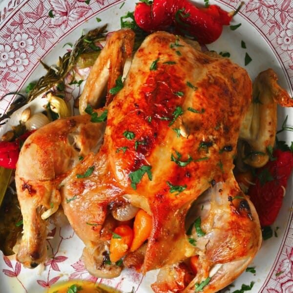 Stuffed roast chicken on a serving platter