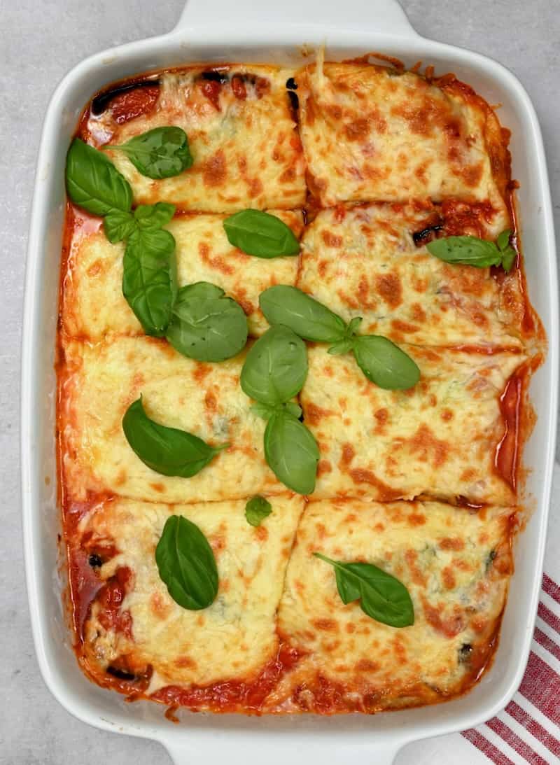 Eggplant parmesan in a baking dish cut into 8 servings