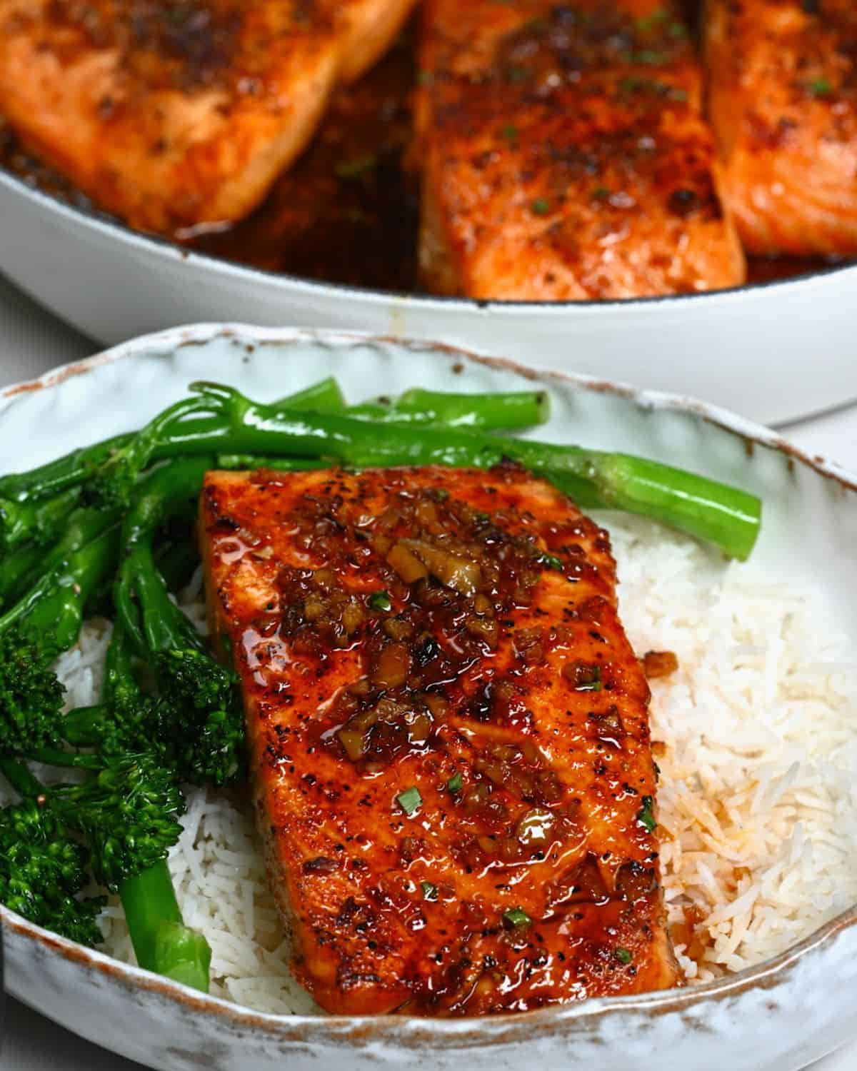 A serving of honey glazed salmon fillet with rice and broccolini