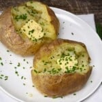 Potatoes cooked in the microwave topped with butter and chives