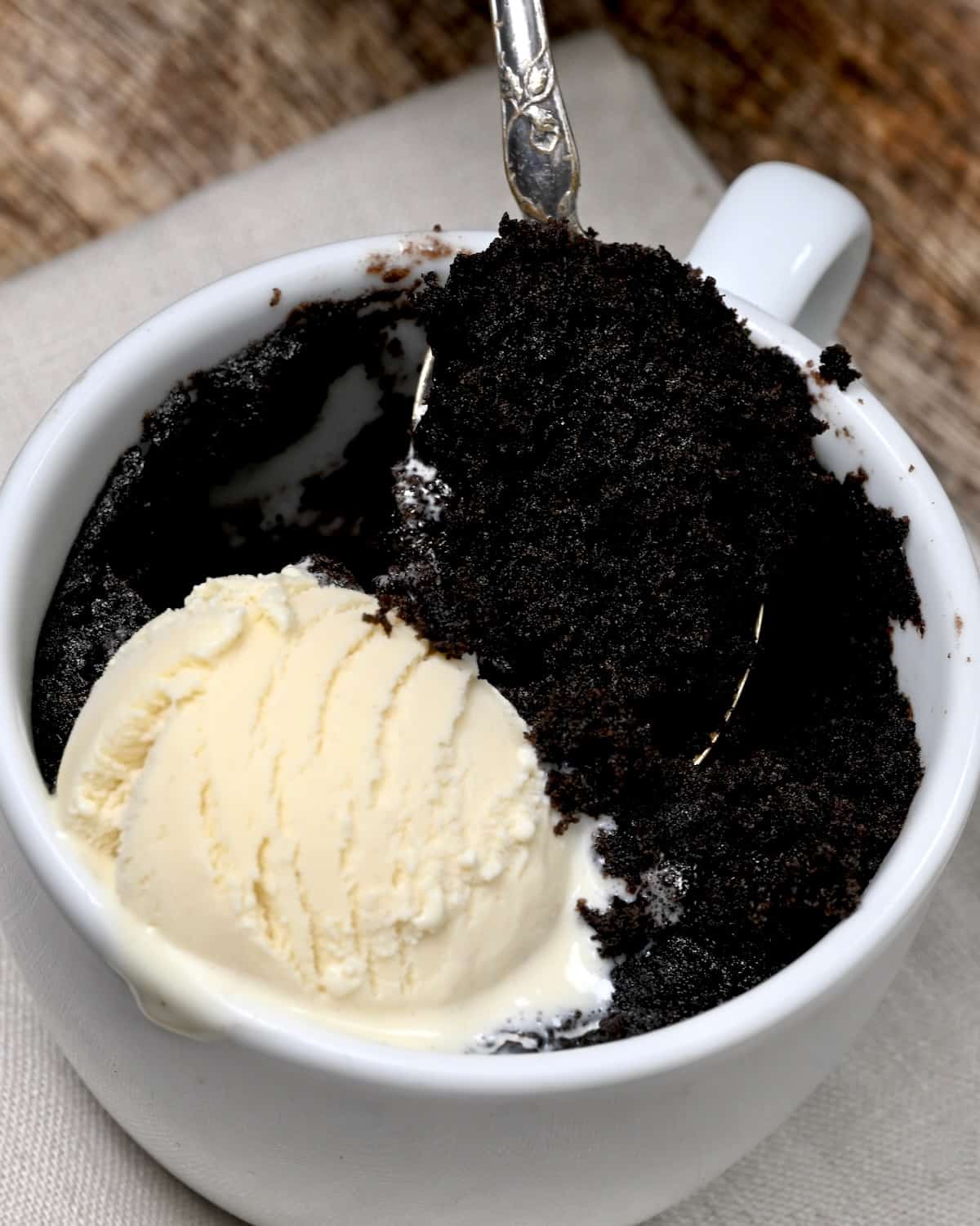 A spoonful of Oreo microwave mug cake with ice cream