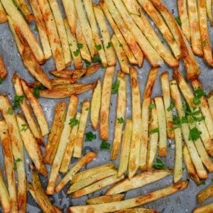 Oven baked French fries on a baking tray