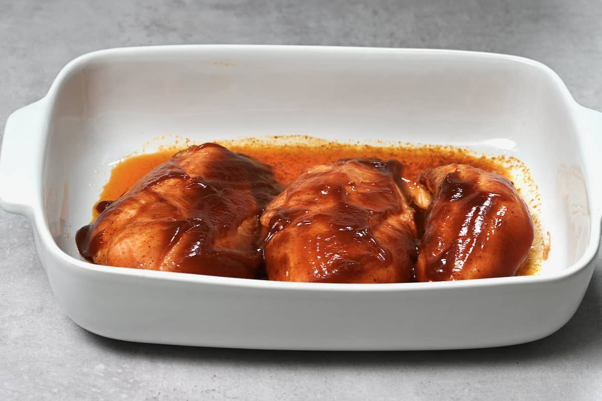 apply the first layer of bbq sauce to the chicken breasts