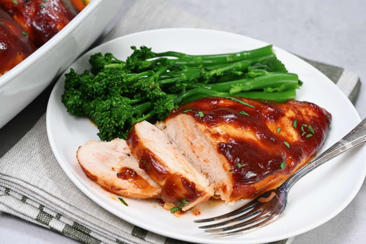 serve the babed bbq chicken breast in a white plate