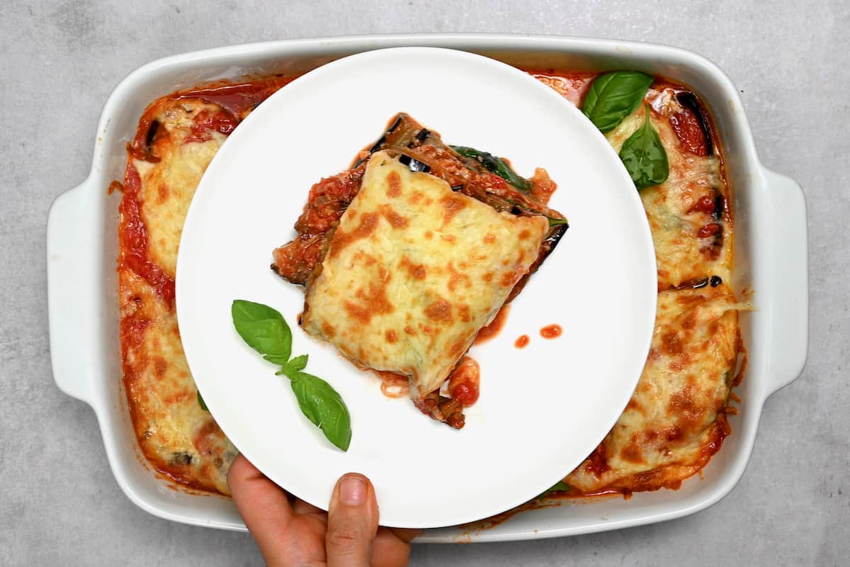 A serving of Eggplant Parmesan on a white plate.