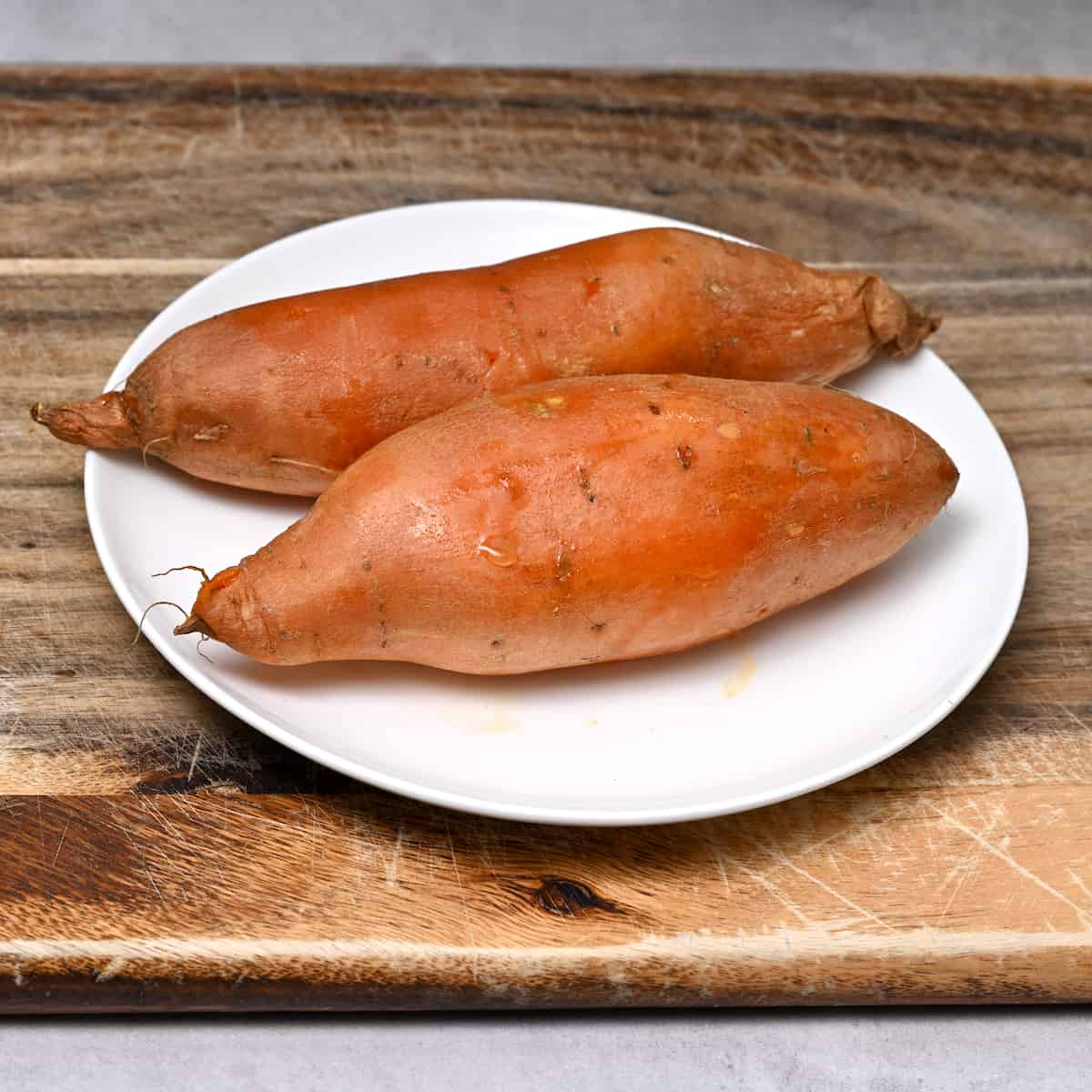 2 medium sized cooked sweet potatoes in a plate