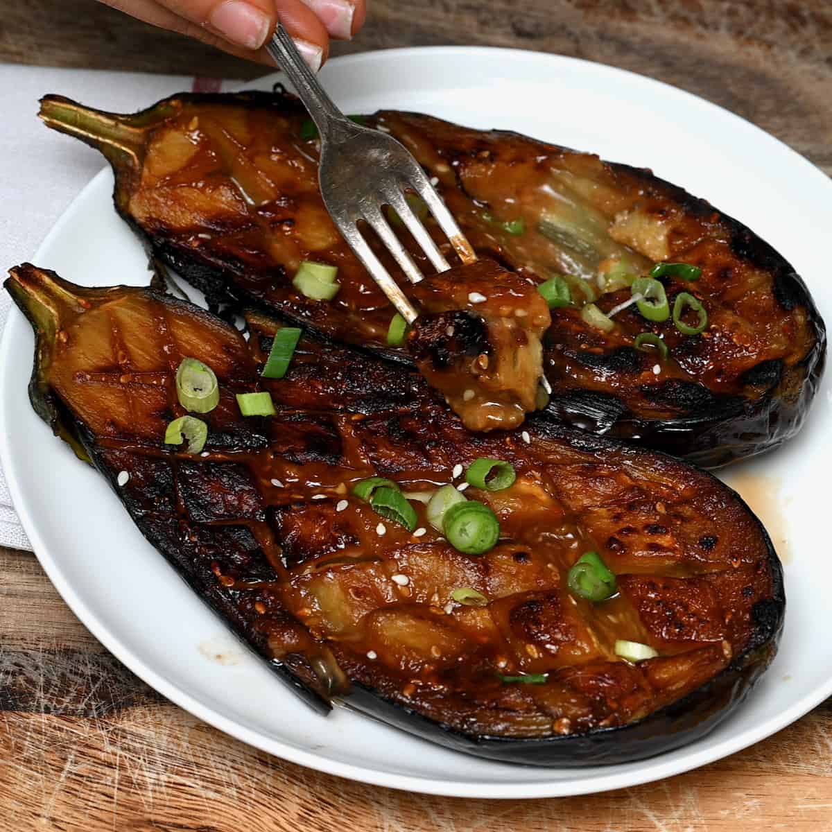 The miso glazes eggplant in a pate garnished with chopped onions and sesame seeds