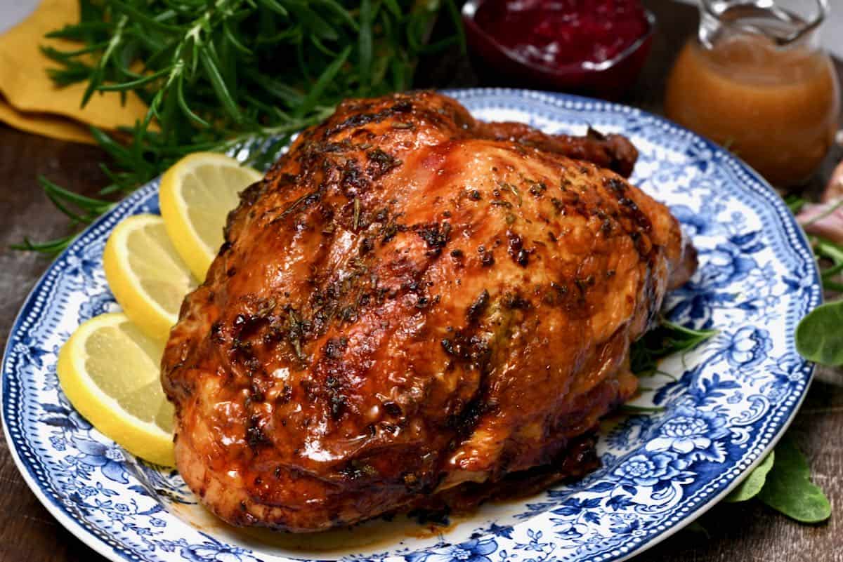 Roast turkey breast on a plate with lemons