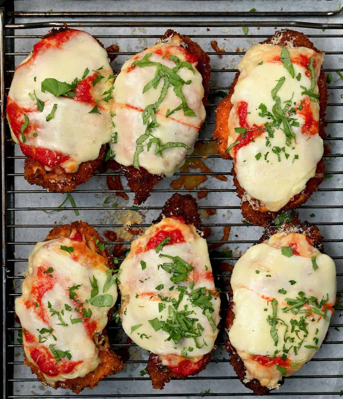 Six chicken parmesan on a wire wrack