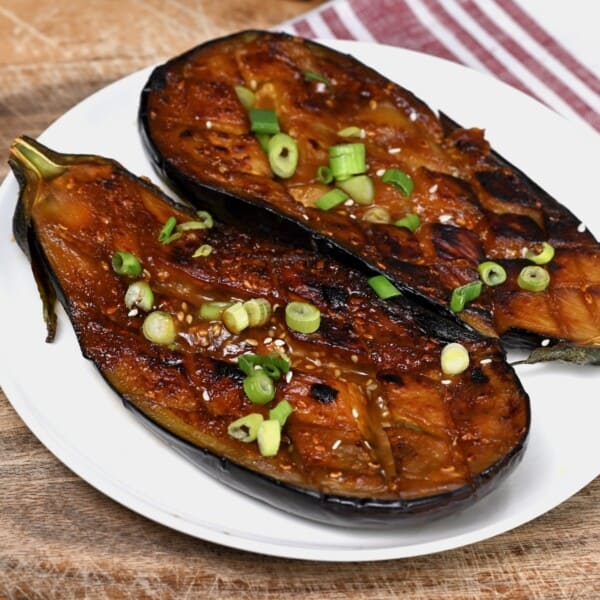 Two miso eggplant halves topped with green onions