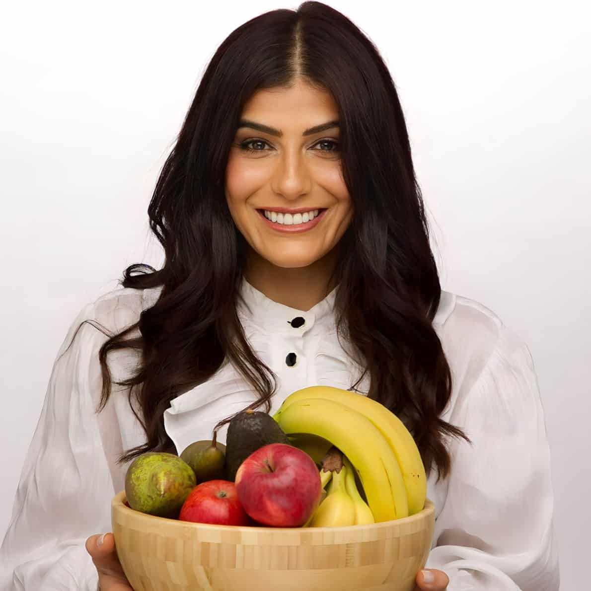 Samira holding a bowl of fruit