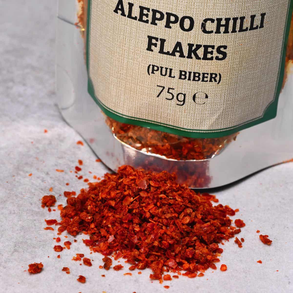 aleppo chilli flakes on grey background