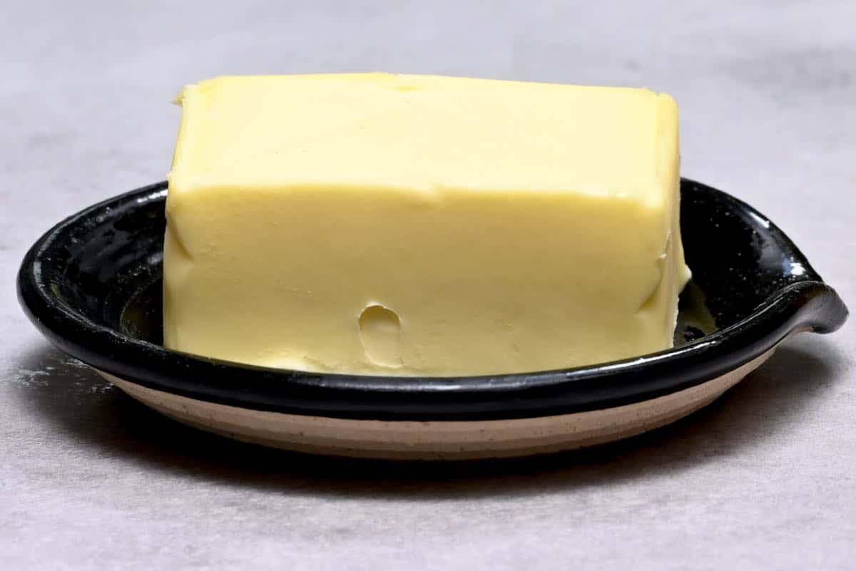 block of butter on a small black plate