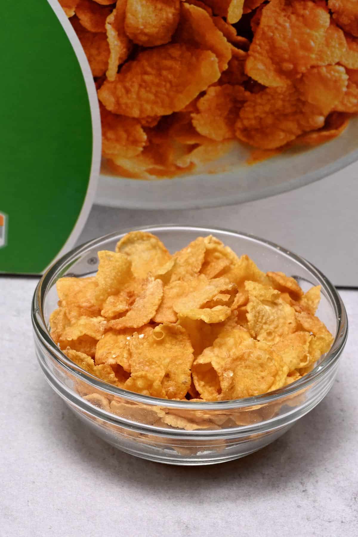 corn flakes in a glass bowl with corn flakes bag behind
