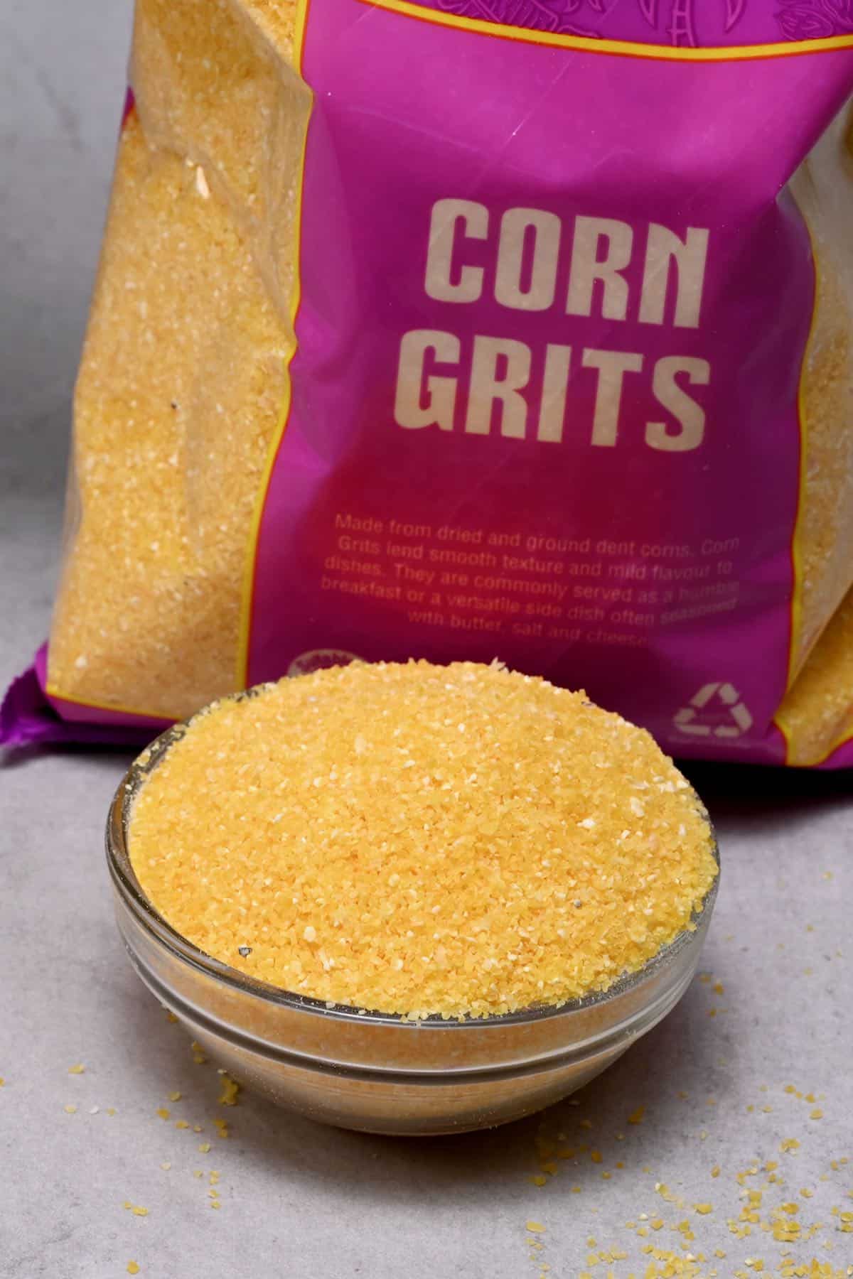 corn grits in a glass bowl with corn grits bag behind