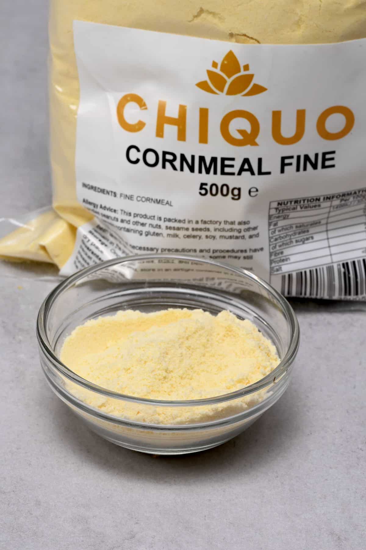 fine cornmeal in a glass bowl with fine cornmeal bag behind