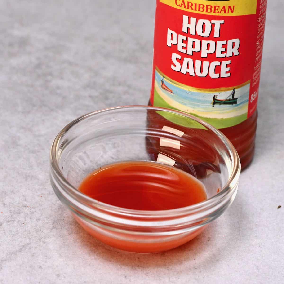 hot pepper sauce inside a small glass bowl