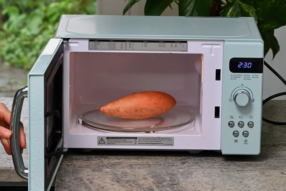 A sweet potato in a microwave oven