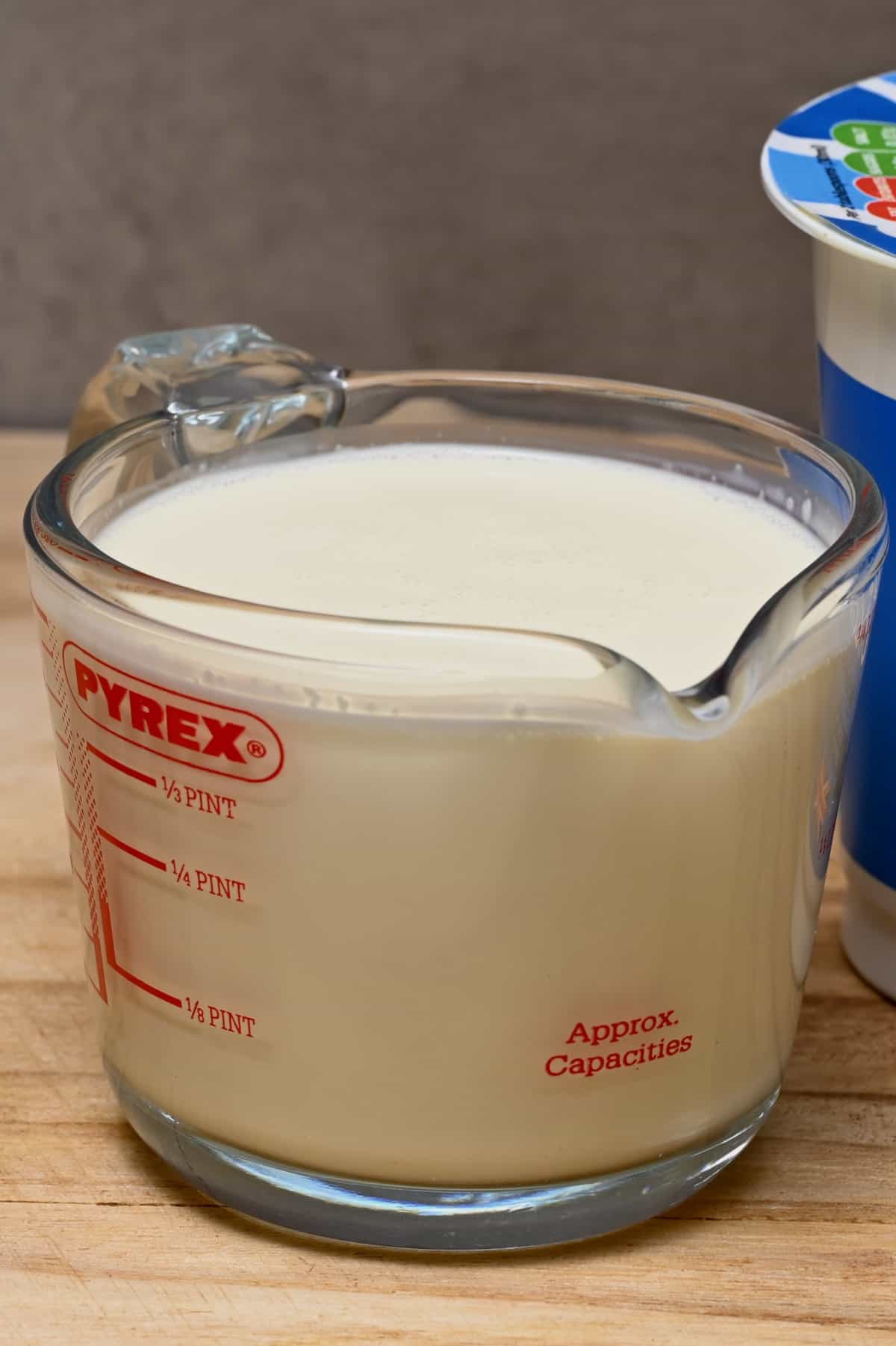side view of a jug of heavy cream