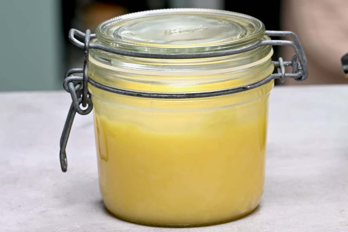 side view of ghee in a glass jar