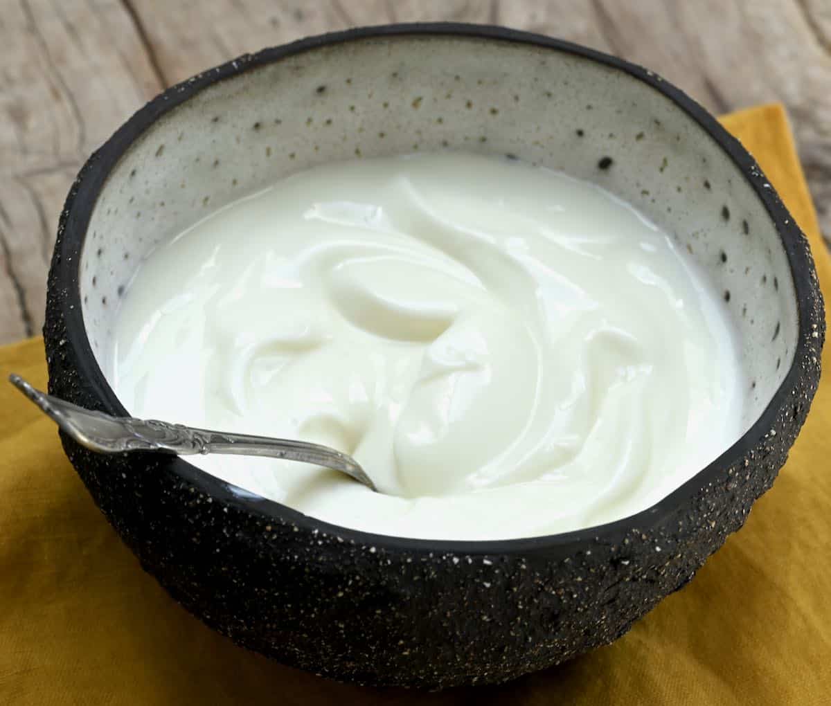 side view of natural yogurt in a bowl