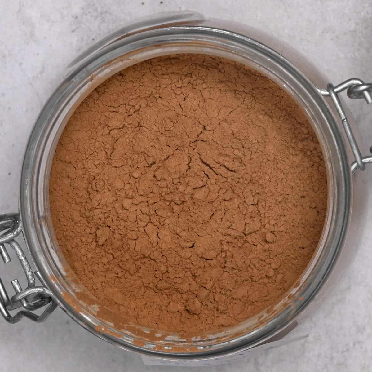 top view of carob powder in a glass jar