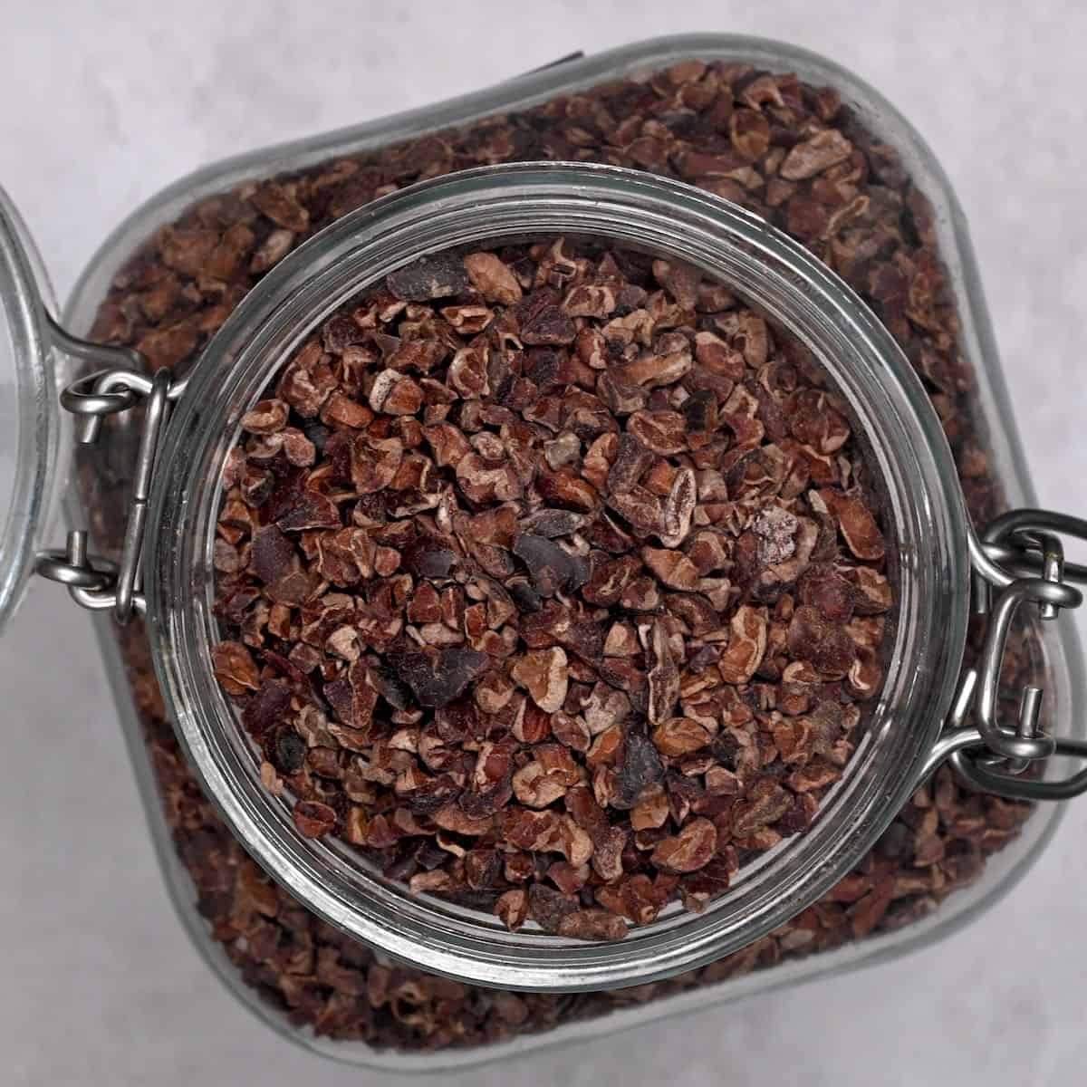 top view of cocoa nibs in a glass jar