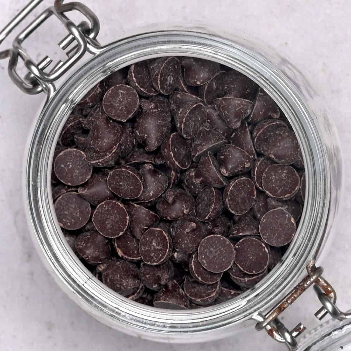 top view of dark chocolate chips in a jar