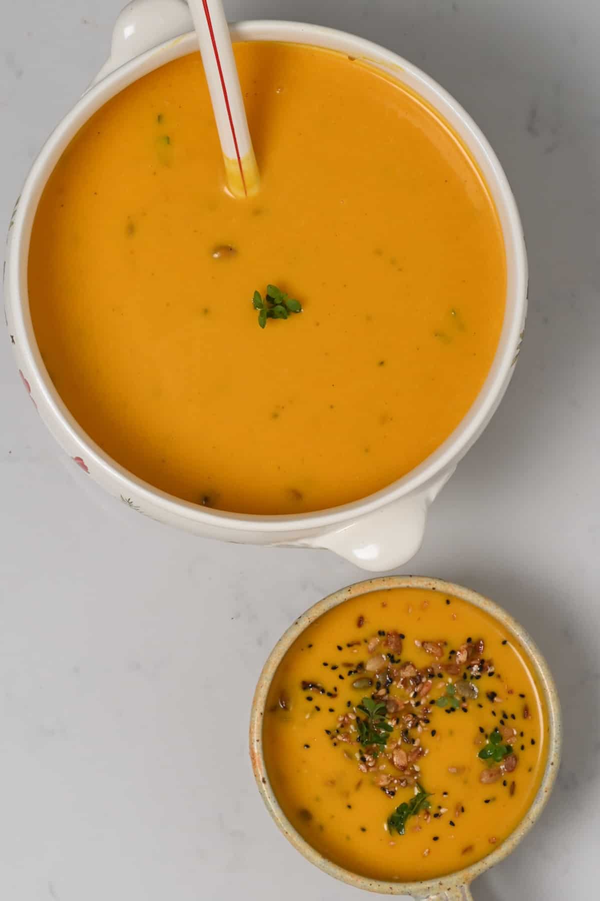 A serving bowl and a small bowl with roasted butternut squash soup