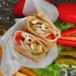 Chicken shawarma prepared into a wrap with vegetables and garlic sauce - 22