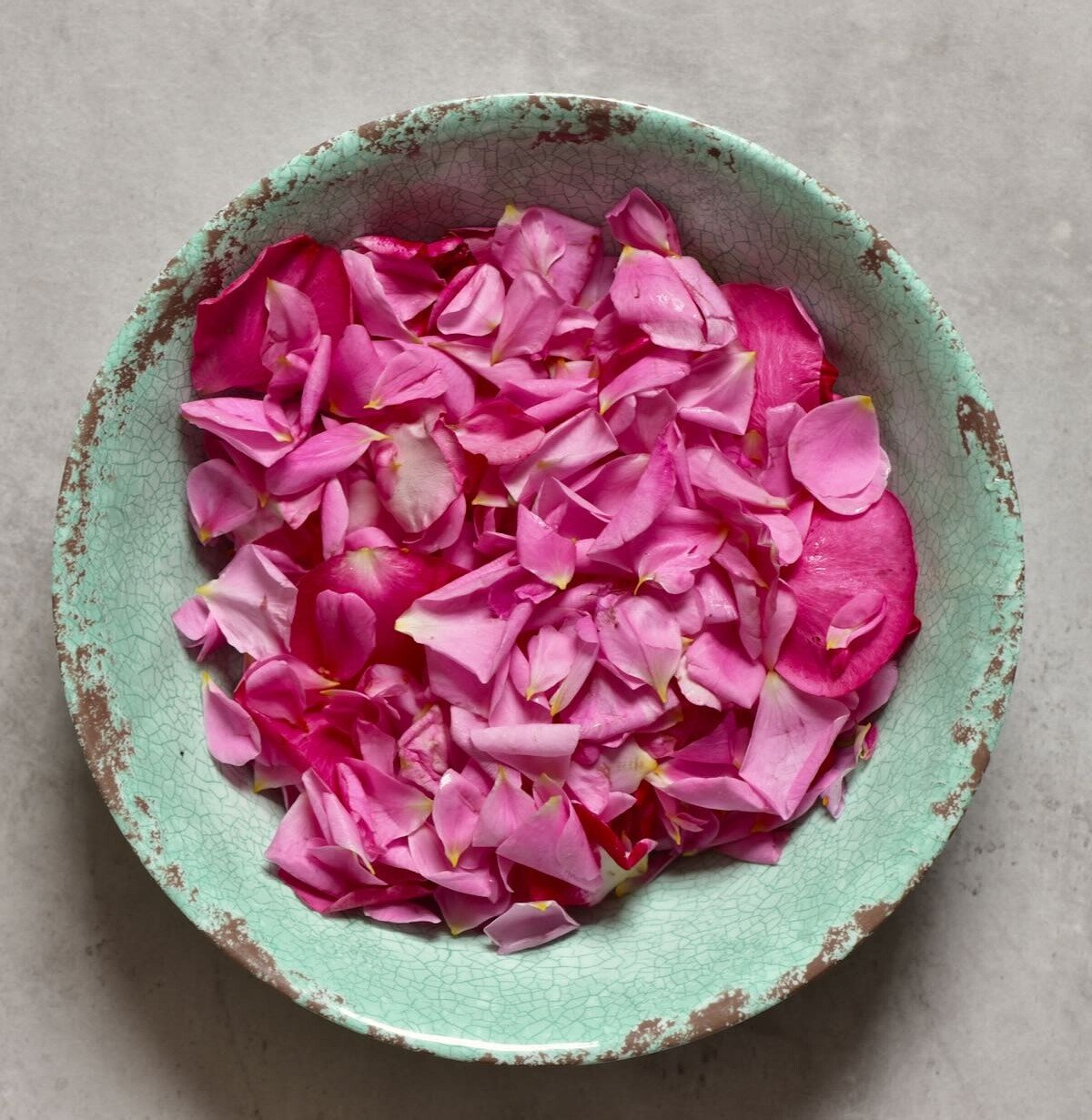 rose petals in green bowl