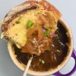 French onion soup in a small bowl topped with cheesy toast - 23