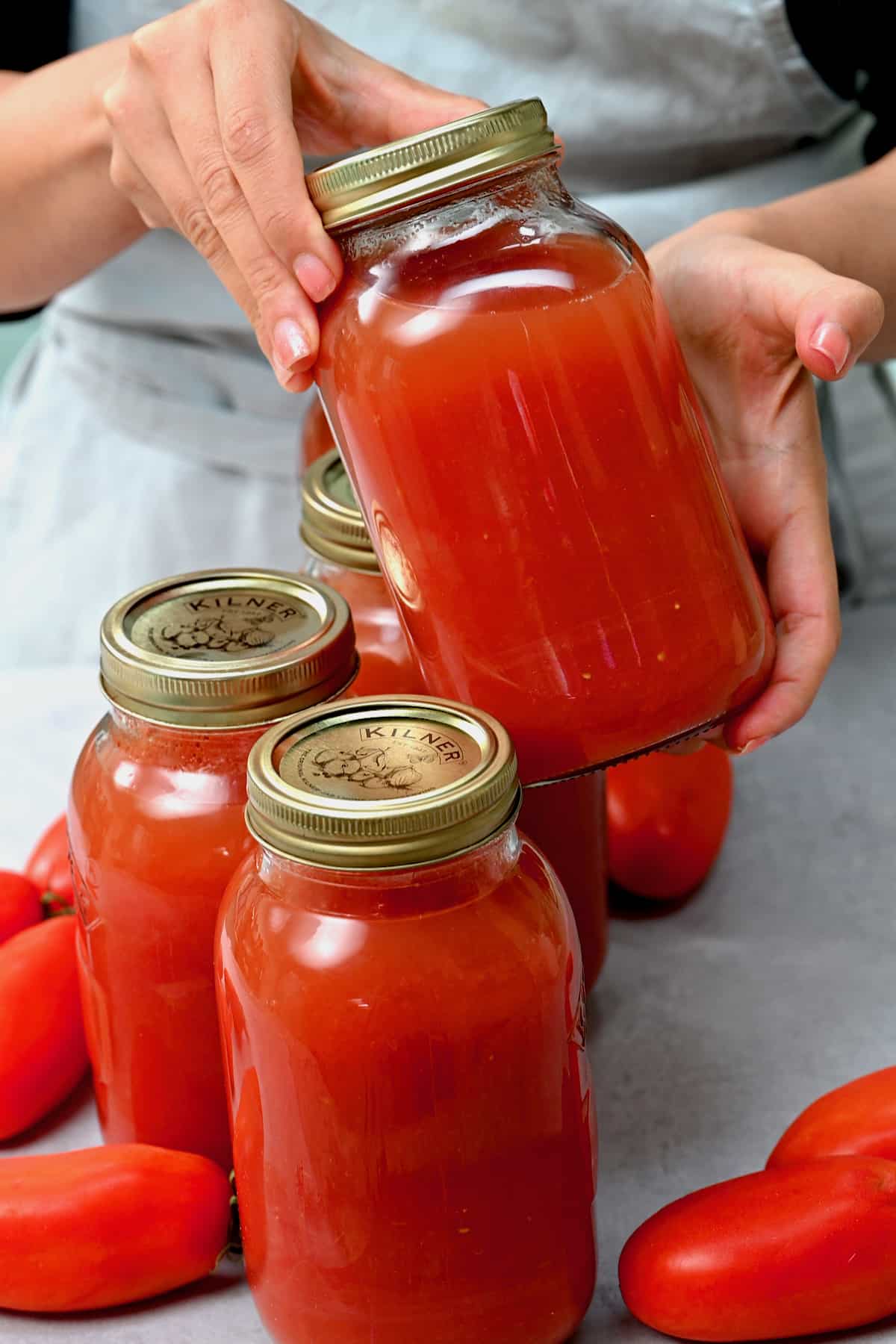 Holding a jar with canned tomato juice