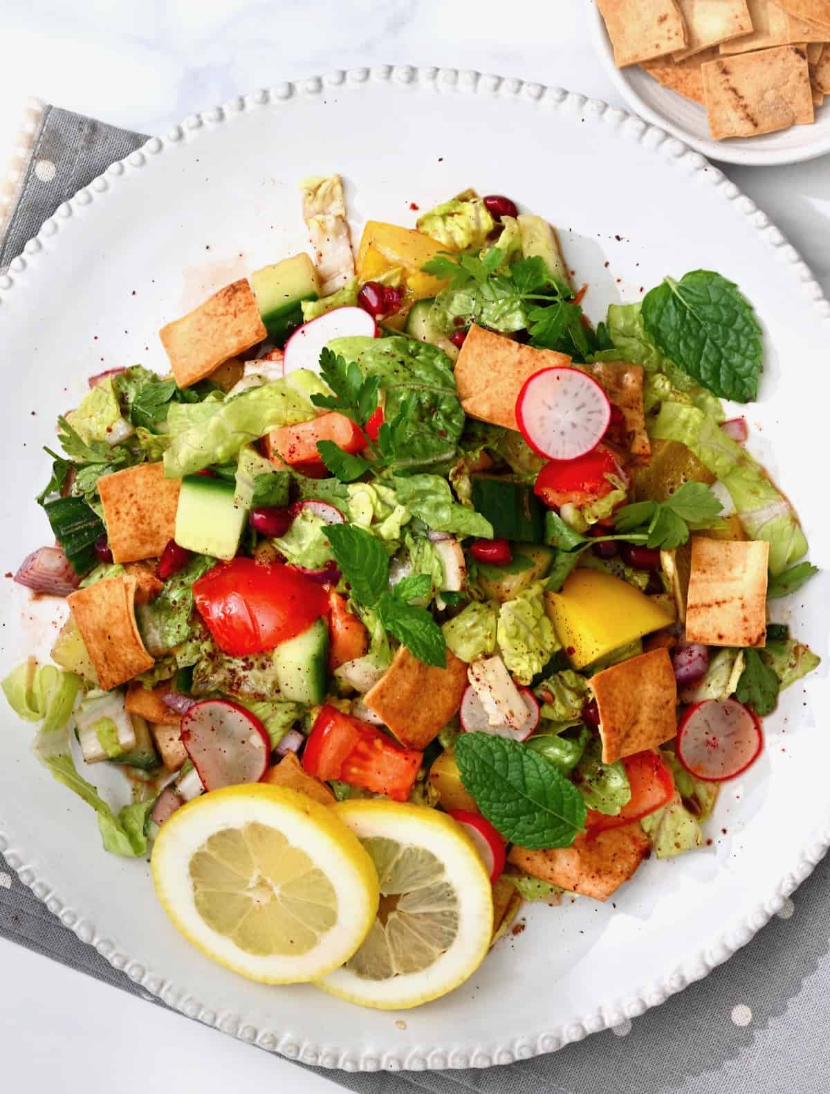 A serving of Lebanese fattoush salad topped with pita chips and mint