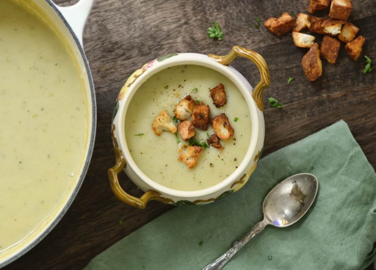 Potato leek soup served in a small bowl and topped with croutons