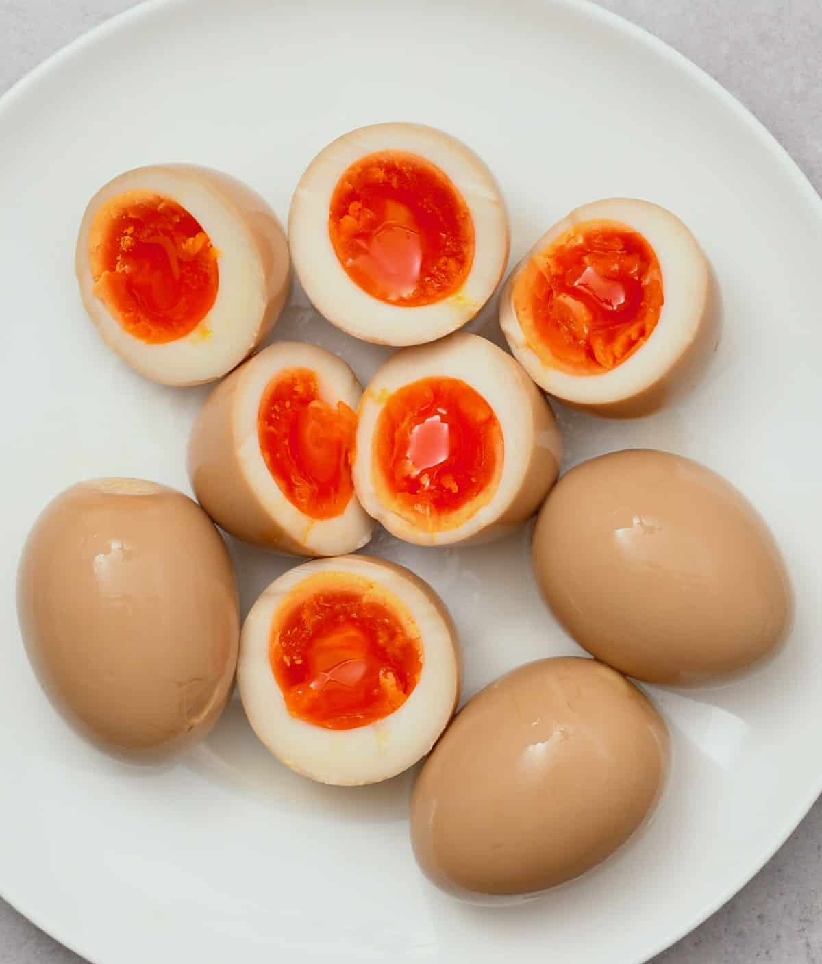 Six ramen eggs, three of which are cut in half
