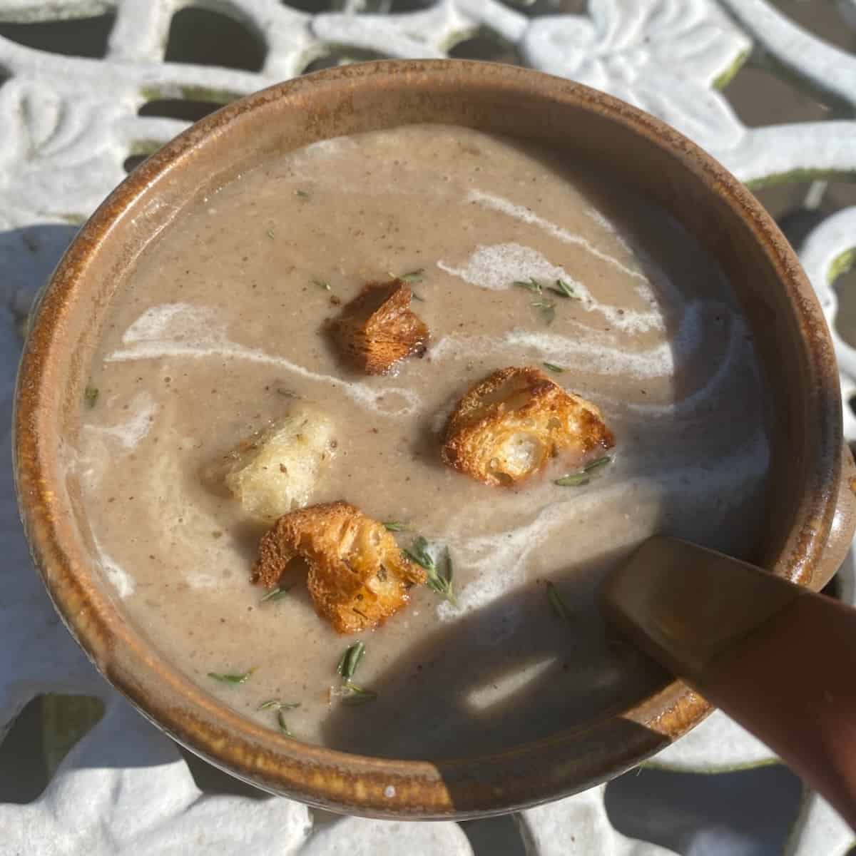 A serving of garlic soup in a small bowl