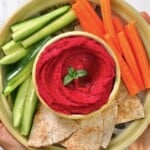 Homemade roasted beet hummus served with carrot and cucumber sticks and pita chips - 21