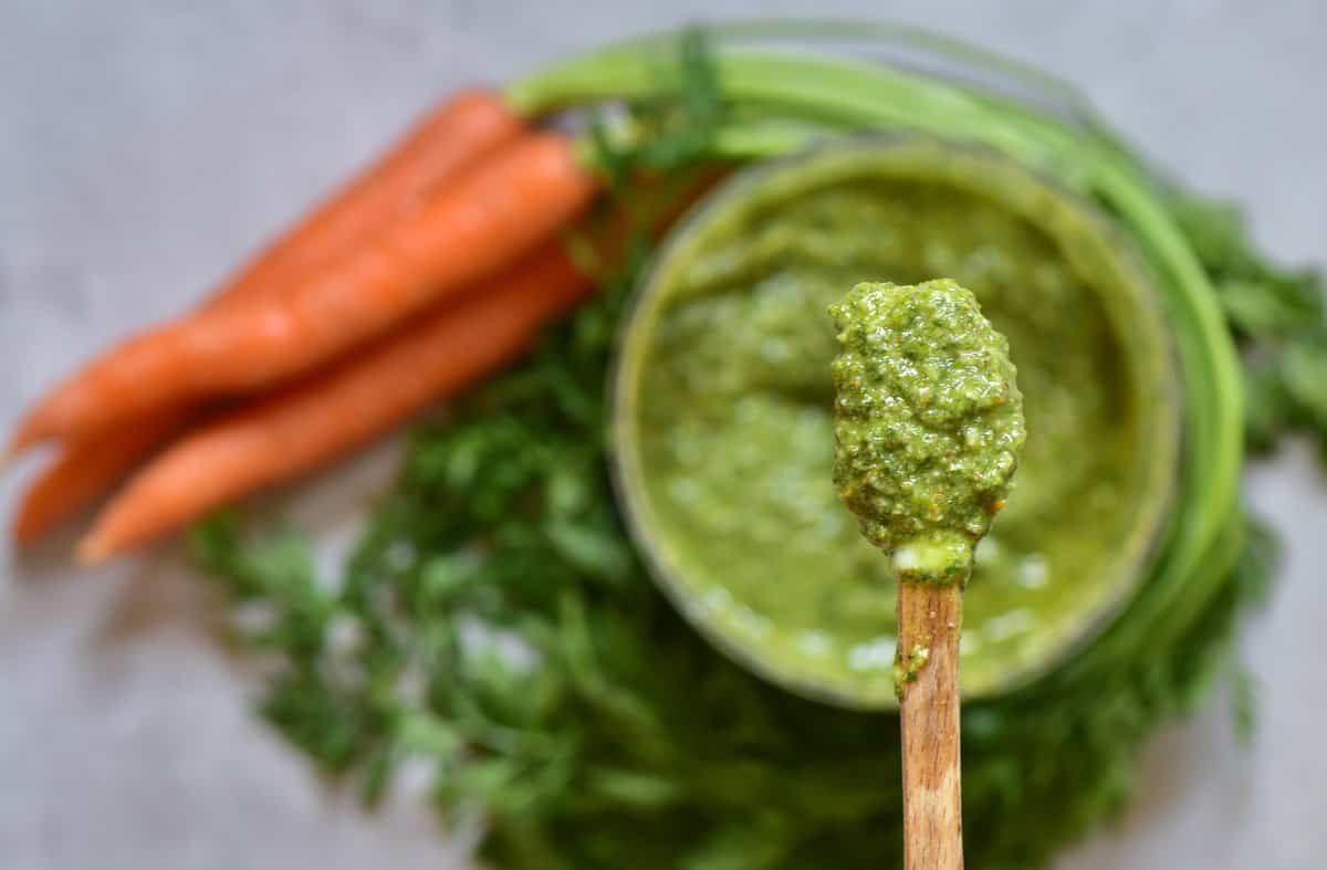 Carrot top pesto in a bowl and in a spoon