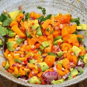 Mango salsa mixed in a bowl with a spoon