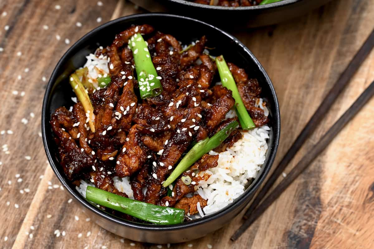 mongolian beef in bowl with chopsticks