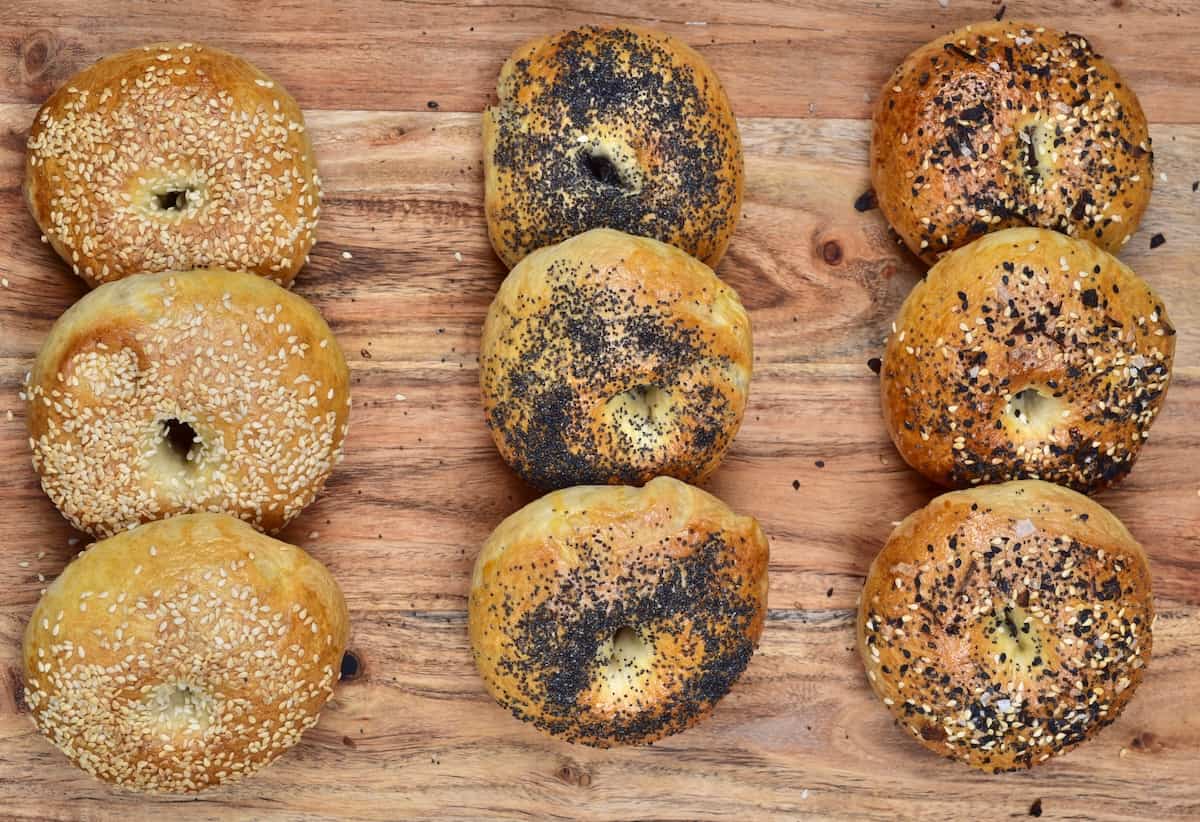 Nine homemade New York-style bagels on a chopping board