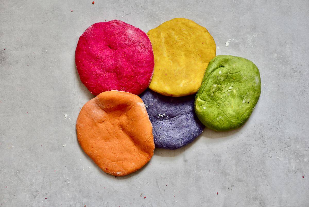 The colored pasta dough: red, purple, orange, yellow, green.