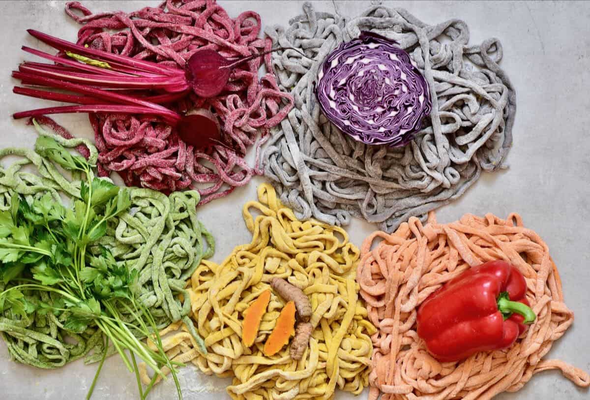 The colored pasta ribbons: red, purple, orange, yellow, green.