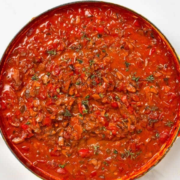 Mushroom ragu in a large pot topped with thyme leaves