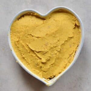 A heart shaped bowl with pumpkin hummus