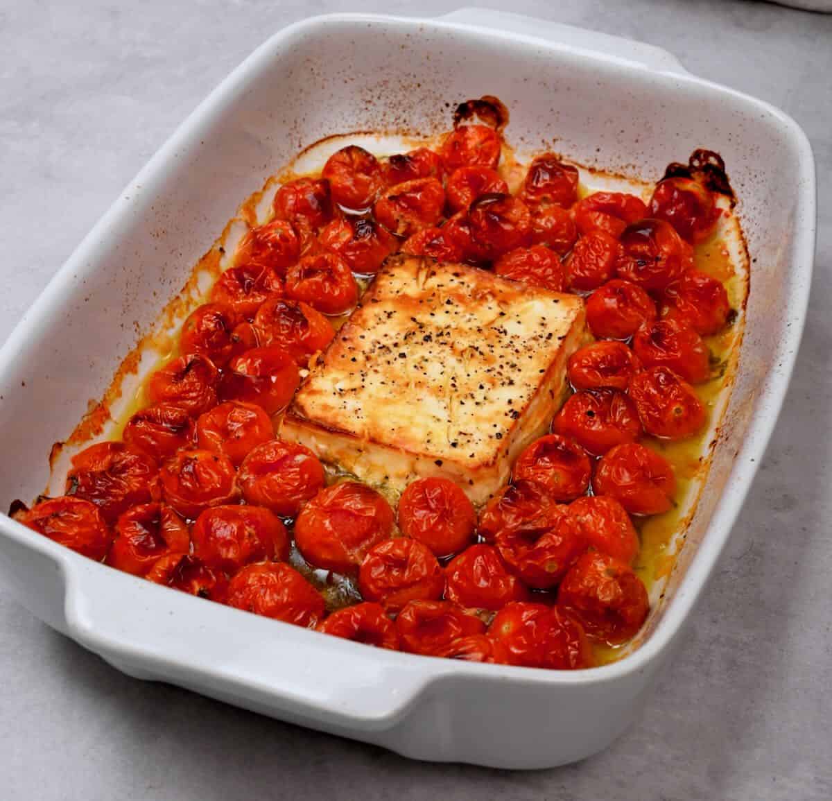 A dish with baked feta and cherry tomatoes